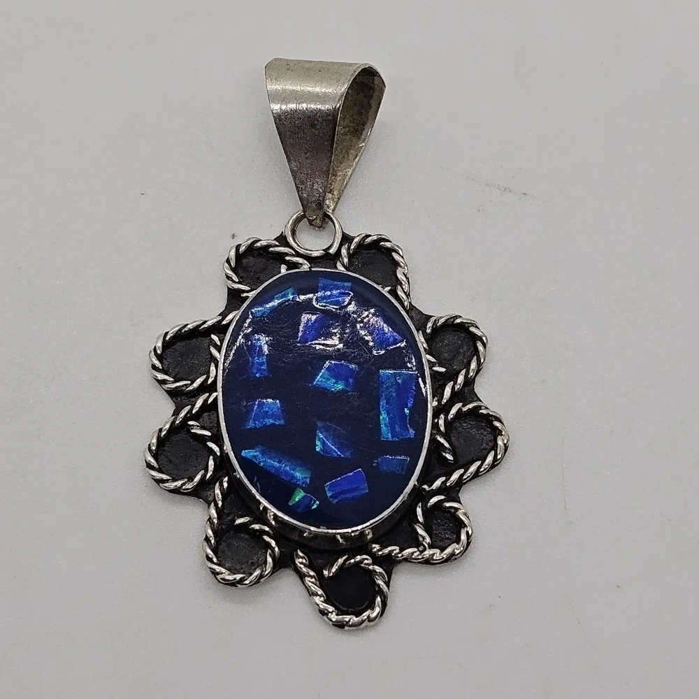 large silver tone pendant with blue opalite chips
